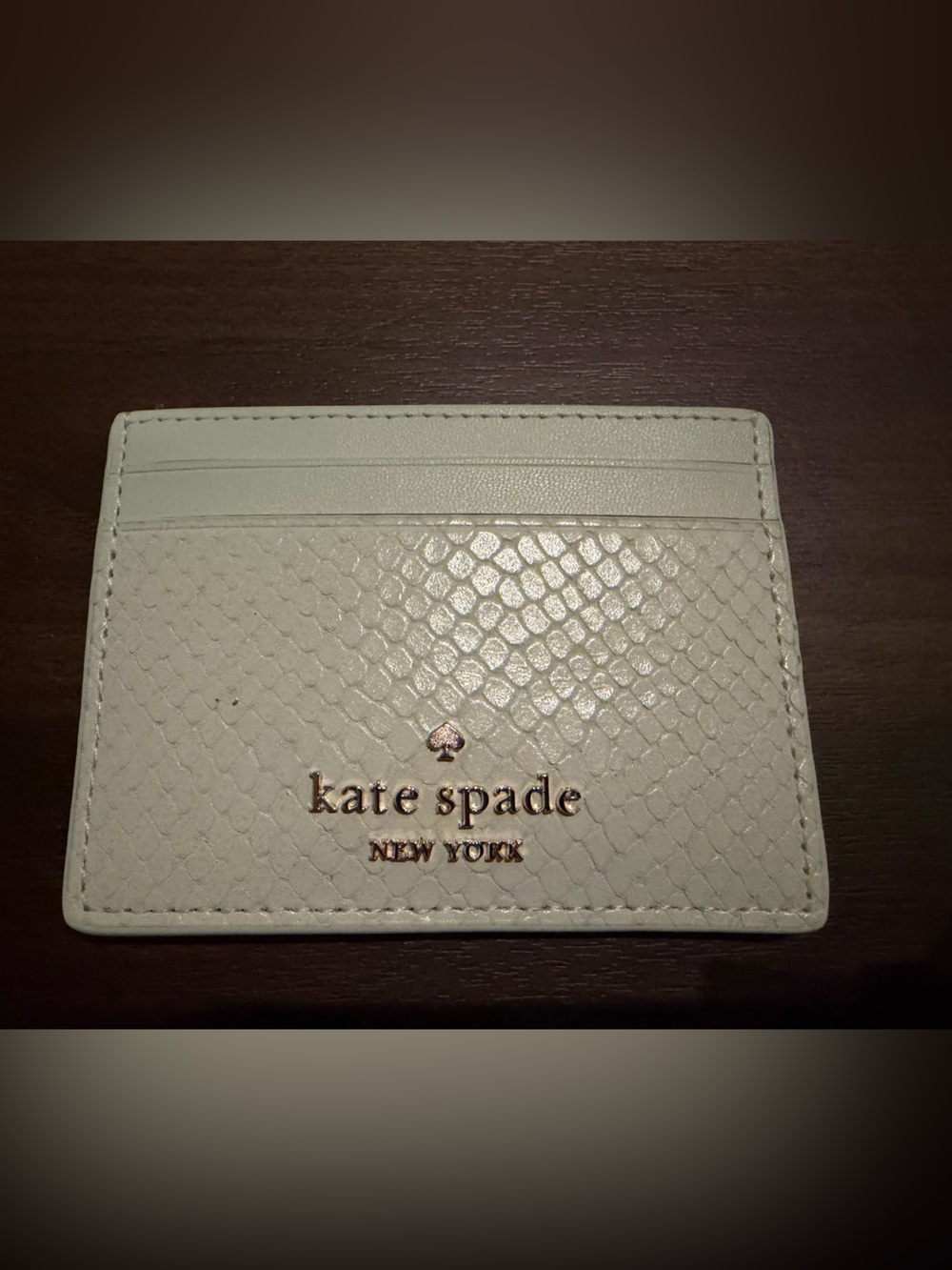 kate spade cream textured card holder with gold logo